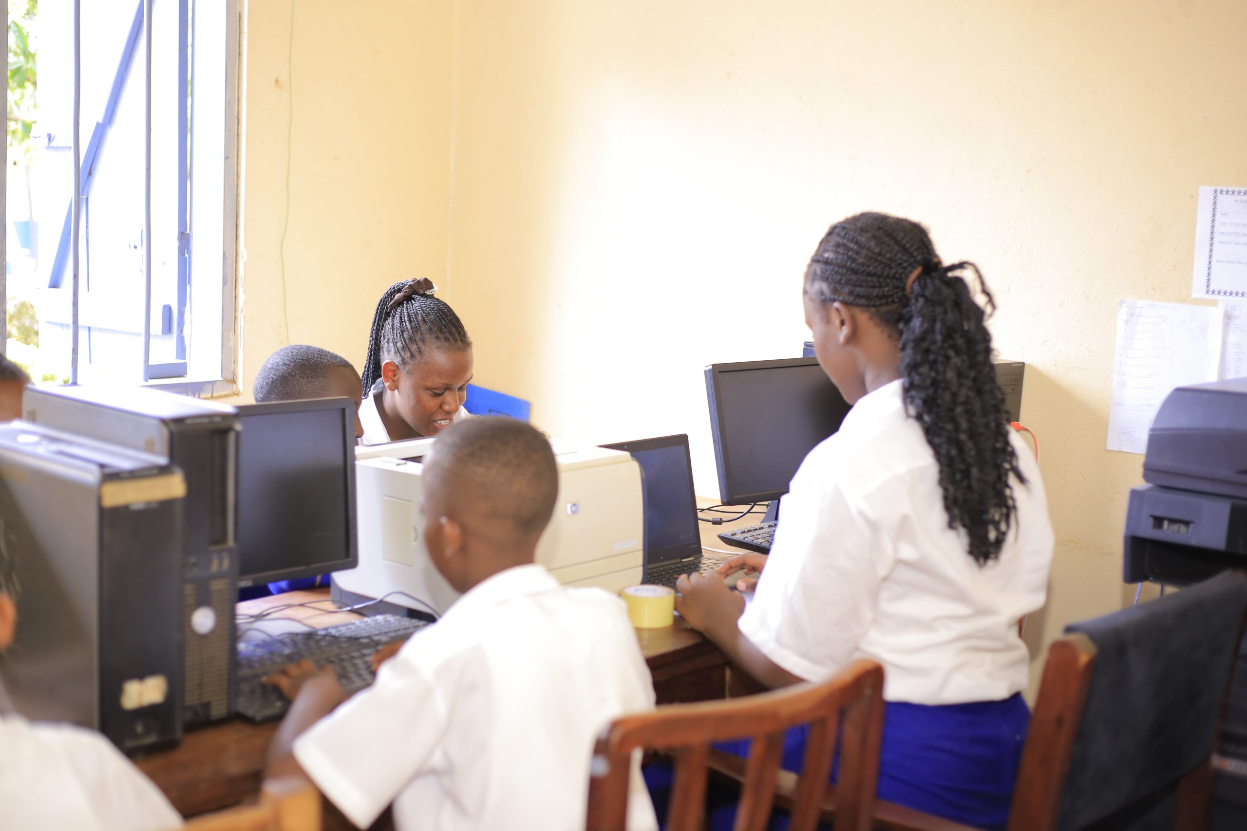 St Jude teachers supporting learners in the computer lab